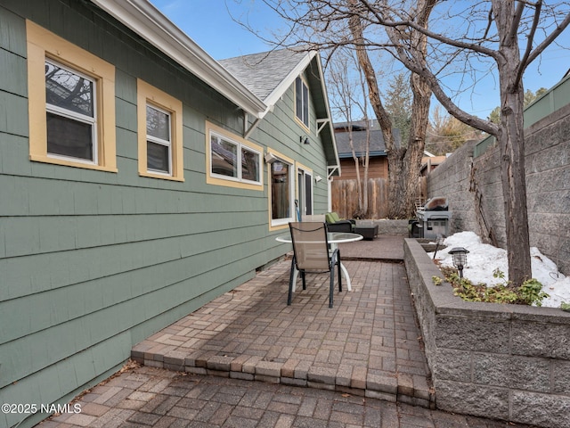 view of patio featuring grilling area and fence