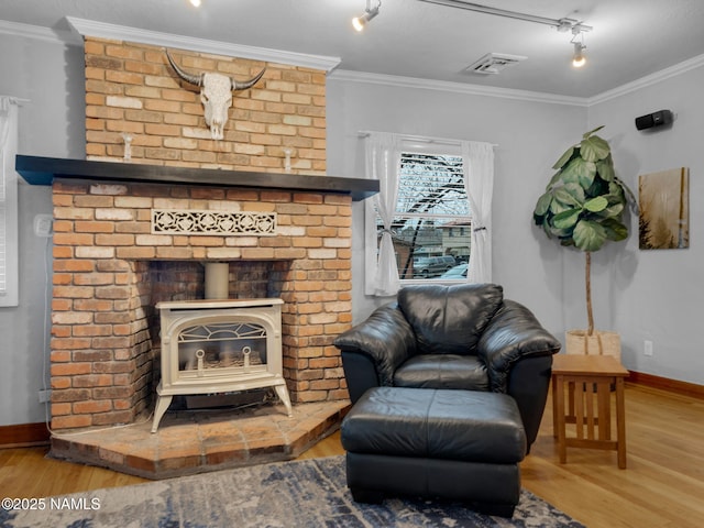 living room featuring visible vents, wood finished floors, and crown molding