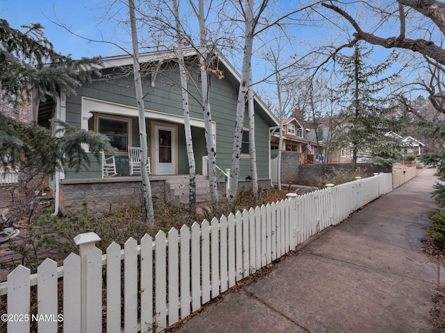 view of front of house with a fenced front yard and covered porch