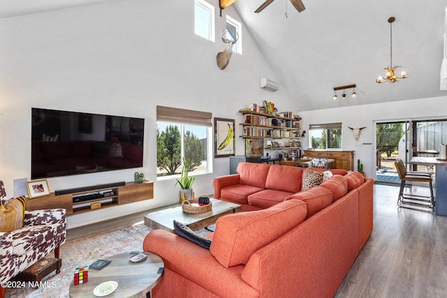 living room featuring wood-type flooring, ceiling fan with notable chandelier, high vaulted ceiling, a wall mounted AC, and beamed ceiling