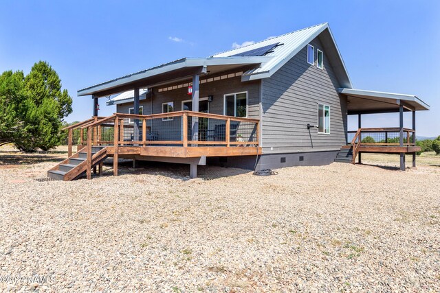 back of house featuring a wooden deck