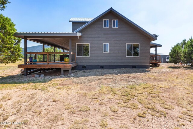 rear view of property featuring a deck