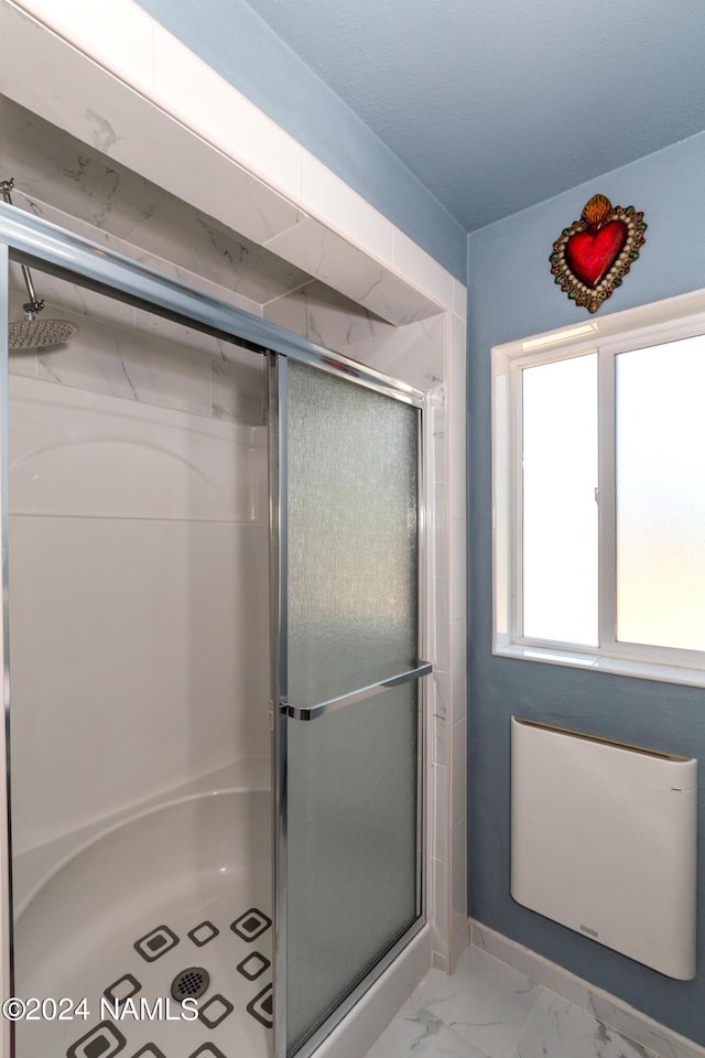 bathroom with a shower with door