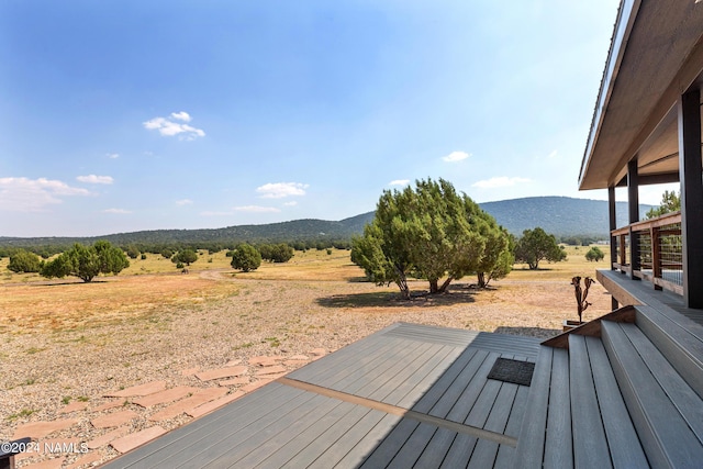 wooden terrace with a mountain view and a rural view