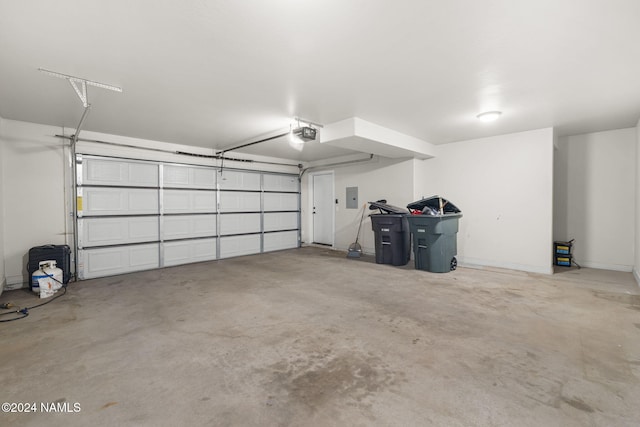 garage featuring electric panel and a garage door opener