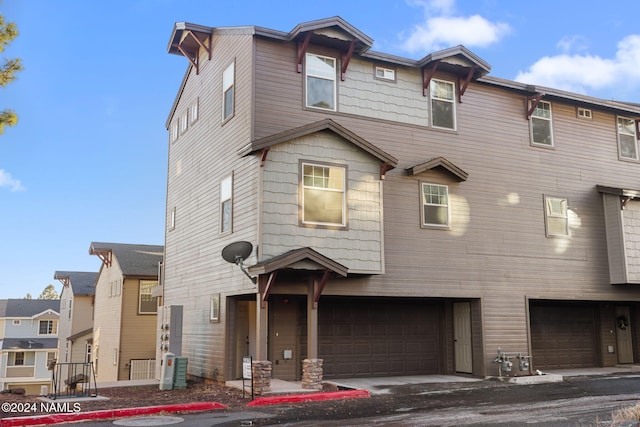 multi unit property featuring a garage