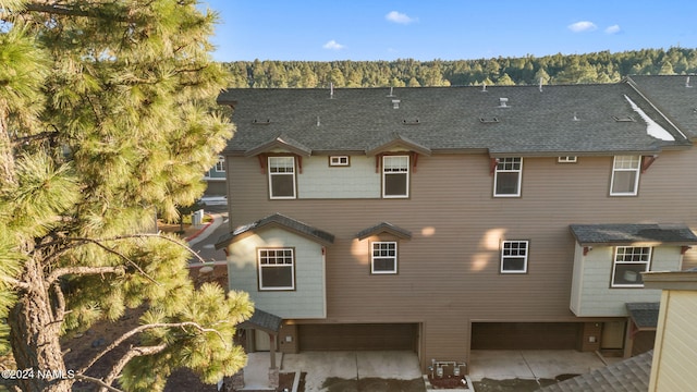 rear view of property with a garage