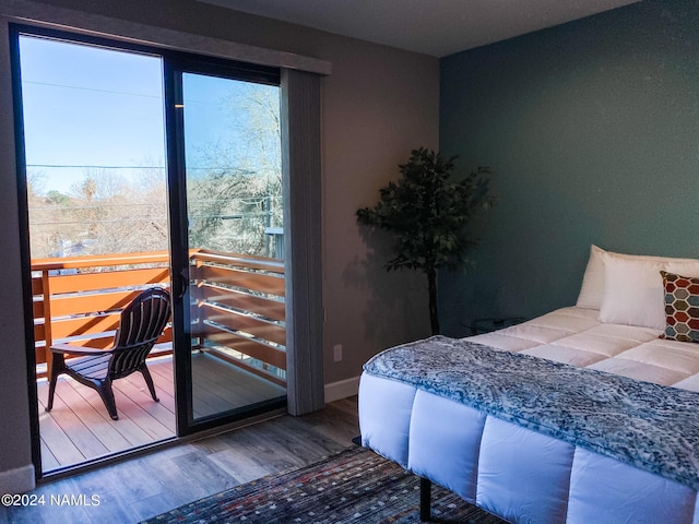 bedroom with wood-type flooring and multiple windows