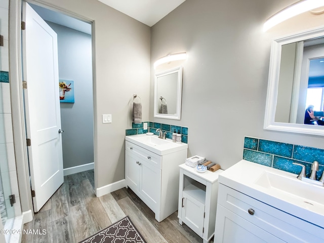 bathroom with hardwood / wood-style floors, tasteful backsplash, and vanity