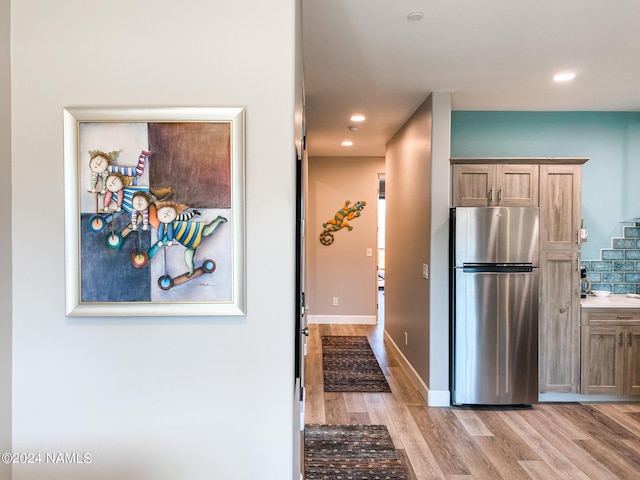 kitchen featuring light wood-type flooring and stainless steel refrigerator