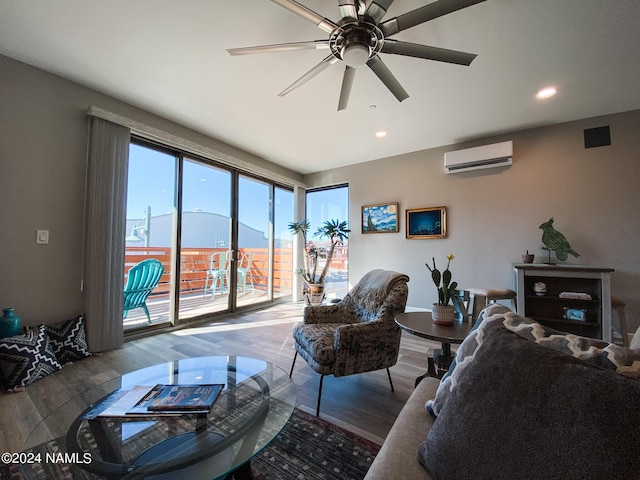 living room with an AC wall unit, hardwood / wood-style floors, and ceiling fan