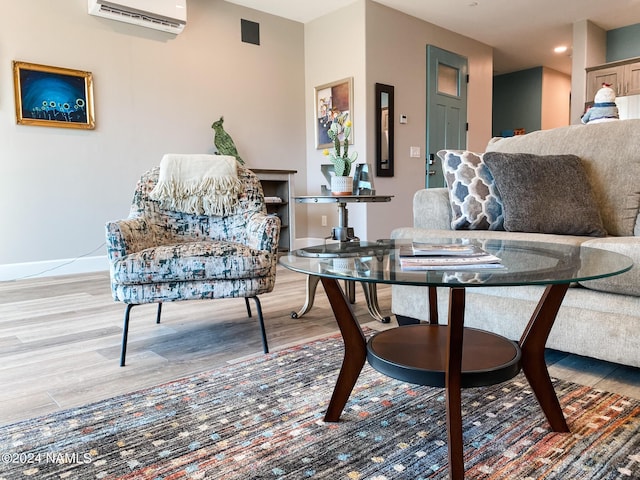 living room featuring an AC wall unit and wood-type flooring