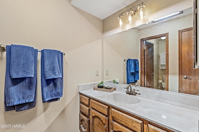 2303 N Plateau Dr, Flagstaff, AZ 86004 - full bathroom with vanity, a textured wall, and a shower