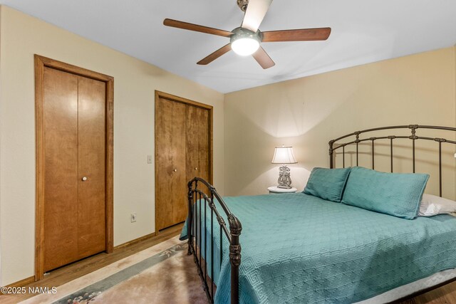 2303 N Plateau Dr, Flagstaff, AZ 86004 - bedroom with multiple closets, wood finished floors, and ceiling fan