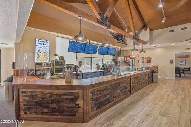 2303 N Plateau Dr, Flagstaff, AZ 86004 - bar area featuring high vaulted ceiling, beamed ceiling, track lighting, light wood-style floors, and pendant lighting