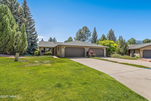 2303 N Plateau Dr, Flagstaff, AZ 86004 - single story home featuring an attached garage, concrete driveway, and a front lawn