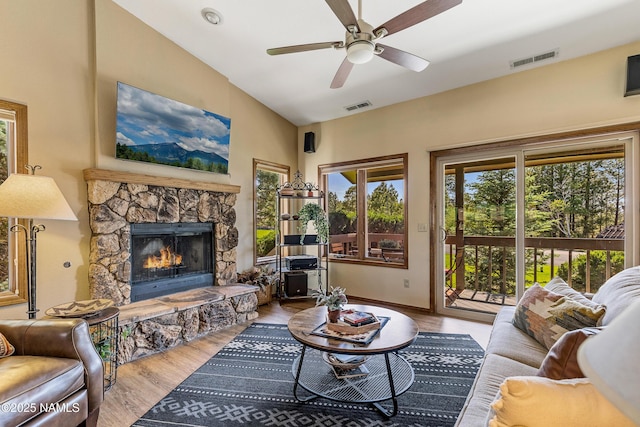 2303 N Plateau Dr, Flagstaff, AZ 86004 - living room featuring a stone fireplace, wood finished floors, a ceiling fan, and vaulted ceiling