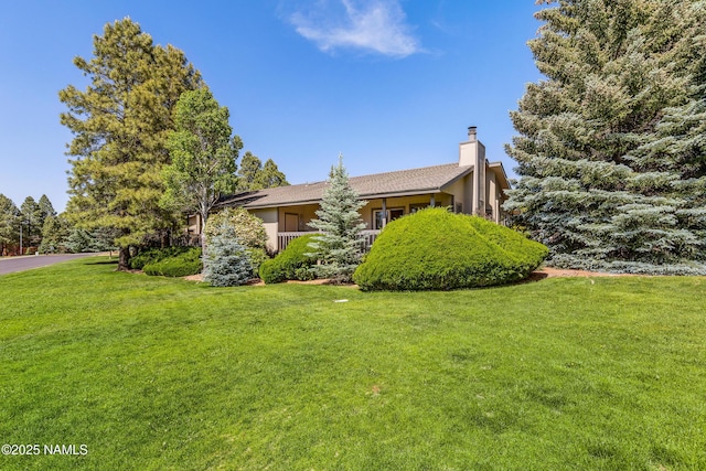 2303 N Plateau Dr, Flagstaff, AZ 86004 - view of home's exterior featuring a yard, a chimney, and stucco siding