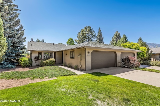 2303 N Plateau Dr, Flagstaff, AZ 86004 - ranch-style home featuring a garage, driveway, a front lawn, and a chimney