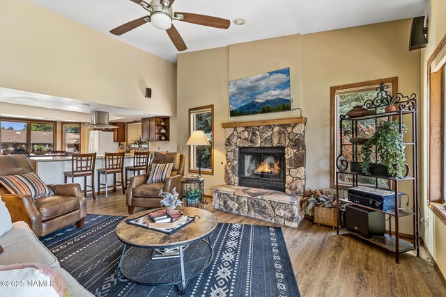 2303 N Plateau Dr, Flagstaff, AZ 86004 - living area featuring a ceiling fan, a fireplace, wood finished floors, and a high ceiling