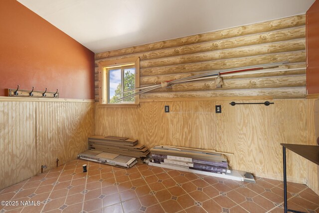 89 N Wyandotte Rd, Williams, AZ 86046 - unfurnished room with rustic walls, wainscoting, and lofted ceiling