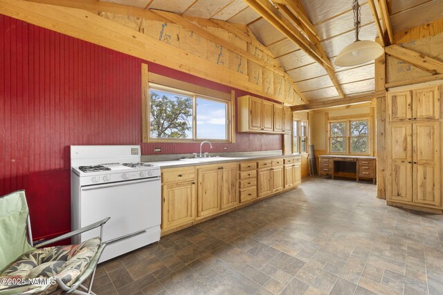 89 N Wyandotte Rd, Williams, AZ 86046 - kitchen with white gas range, a sink, lofted ceiling, wooden walls, and light countertops