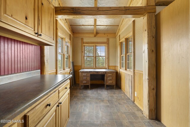 89 N Wyandotte Rd, Williams, AZ 86046 - kitchen featuring stone finish flooring, a wainscoted wall, dark countertops, and wooden walls