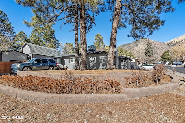 ranch-style home with a mountain view and a garage