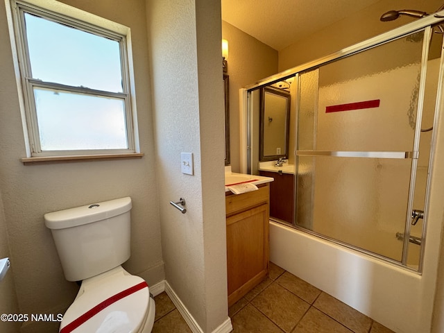 7840 Cowboy Way, Flagstaff, AZ 86004 - full bathroom with vanity, toilet, tile patterned flooring, and bath / shower combo with glass door