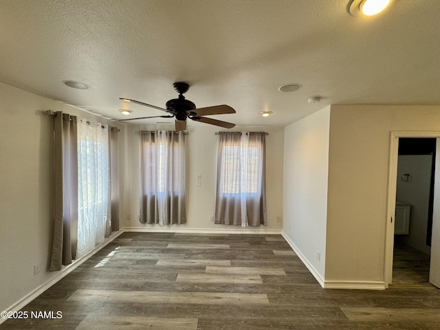 7840 Cowboy Way, Flagstaff, AZ 86004 - spare room featuring a textured ceiling, wood finished floors, plenty of natural light, ceiling fan, and baseboards