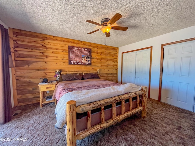 3153 Pinetree Dr, Williams, AZ 86046 - carpeted bedroom with a textured ceiling, wood walls, and ceiling fan