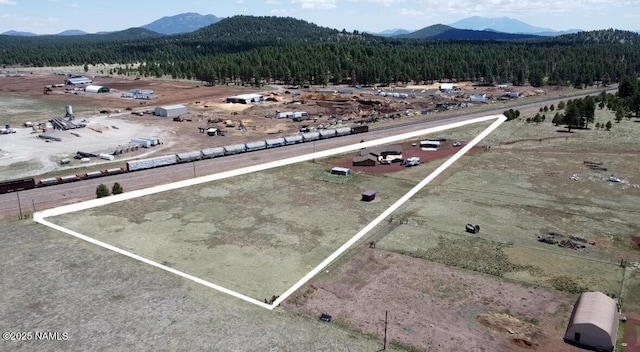 3153 Pinetree Dr, Williams, AZ 86046 - aerial view of property and surrounding area with a mountainous background, property boundaries highlighted, and a forest