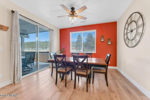 dining area with ceiling fan and light hardwood / wood-style floors