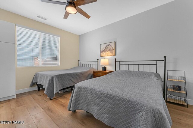 bedroom with ceiling fan and light hardwood / wood-style floors