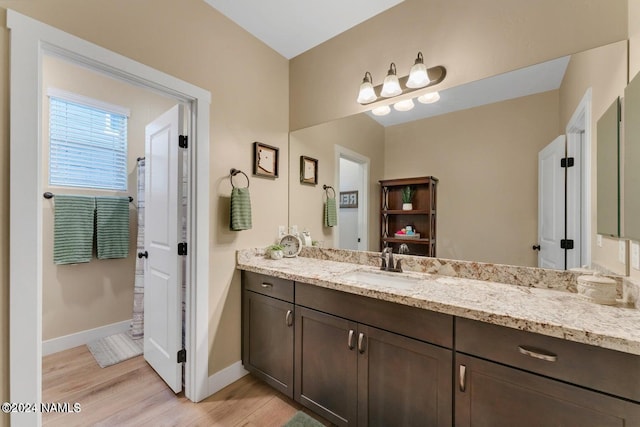 bathroom with hardwood / wood-style flooring and vanity