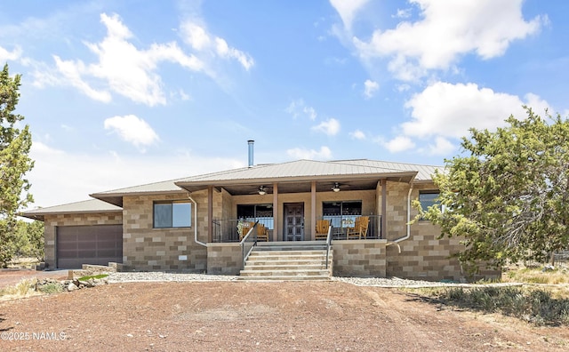 1384 W Canvasback Trl, Williams, AZ 86046 - view of front facade with ceiling fan, an attached garage, a metal roof, a porch, and driveway
