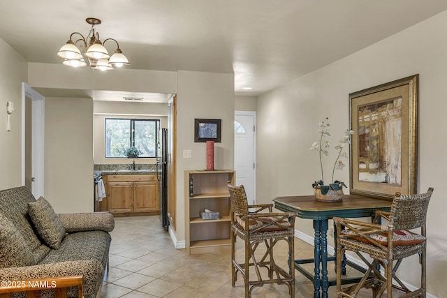 3200 S Litzler Dr Unit 3-212, Flagstaff, AZ 86005 - dining area featuring a chandelier, light tile patterned floors, and baseboards