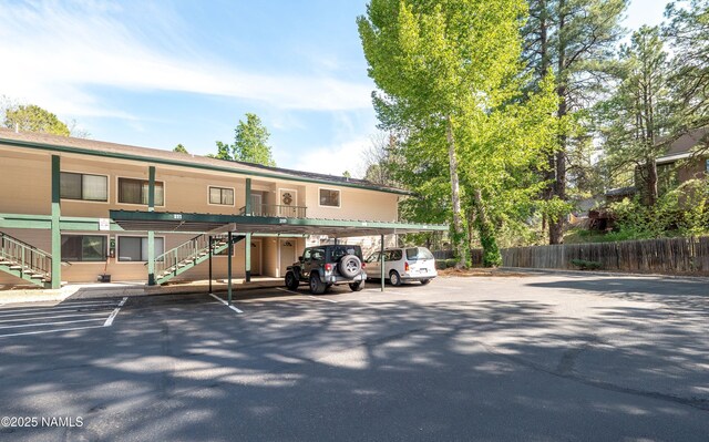 3200 S Litzler Dr Unit 3-212, Flagstaff, AZ 86005 - view of building exterior featuring stairway and covered parking