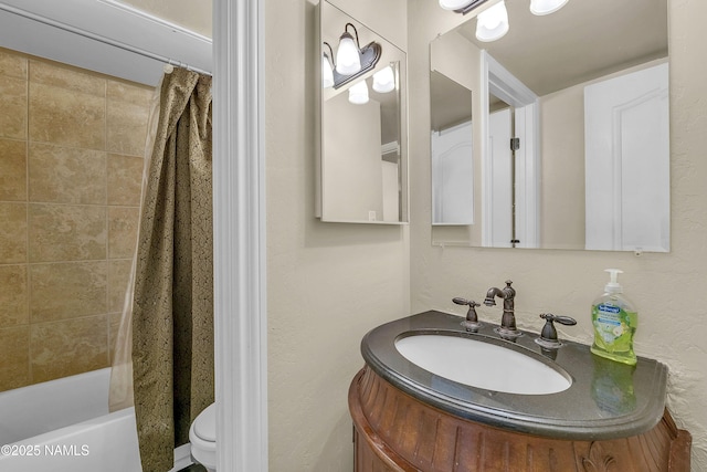 3200 S Litzler Dr Unit 3-212, Flagstaff, AZ 86005 - bathroom featuring vanity, shower / tub combo with curtain, toilet, and a textured wall