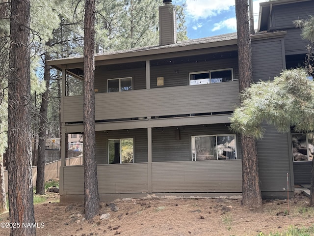 1385 W University Ave Unit 196, Flagstaff, AZ 86001 - rear view of house featuring a chimney and a balcony
