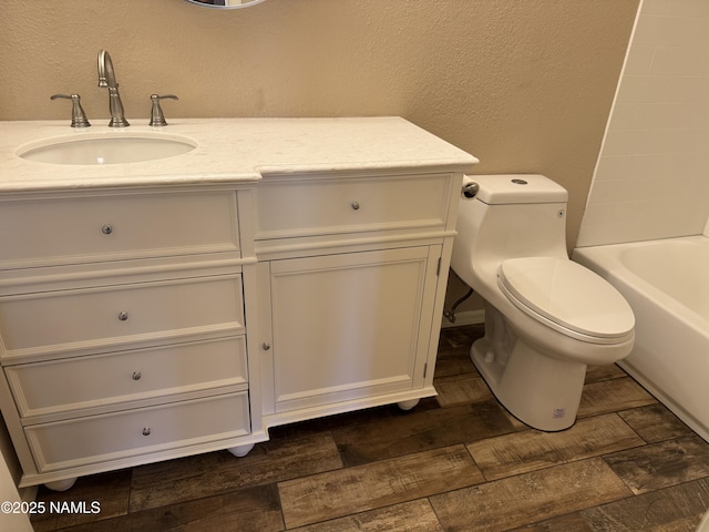 1385 W University Ave Unit 196, Flagstaff, AZ 86001 - full bathroom featuring a textured wall, vanity, toilet, and shower / bath combination