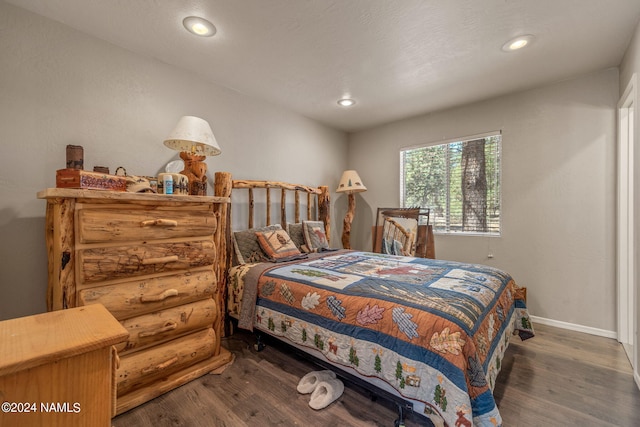 bedroom featuring dark hardwood / wood-style flooring