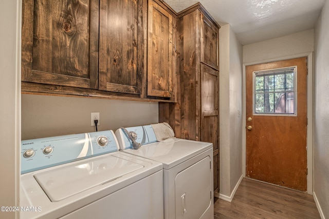 laundry room featuring hardwood / wood-style flooring, cabinets, and independent washer and dryer