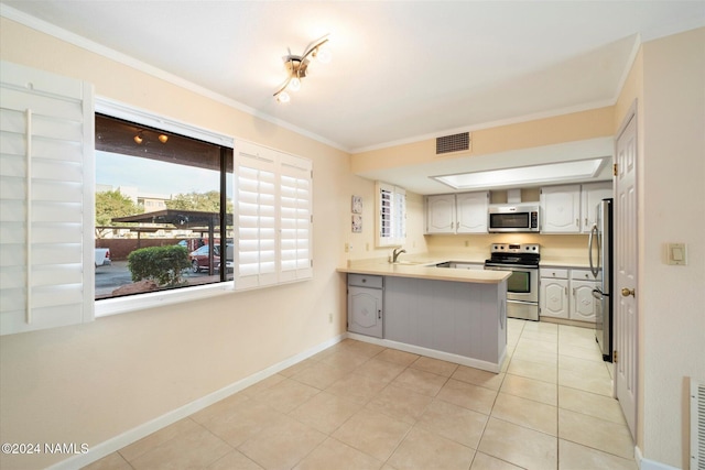 kitchen with ornamental molding, white cabinetry, kitchen peninsula, and appliances with stainless steel finishes