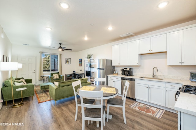 kitchen with sink, white cabinetry, wood-type flooring, ceiling fan, and stainless steel appliances