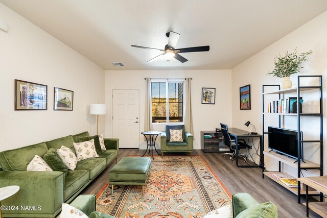 living room featuring hardwood / wood-style flooring and ceiling fan