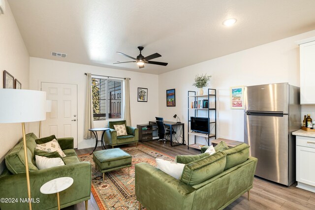 living room featuring ceiling fan and light wood-type flooring