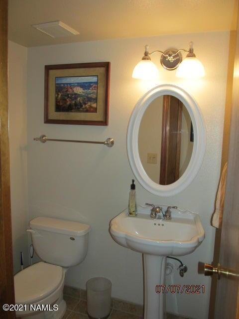 2422 N Whispering Pines Way, Flagstaff, AZ 86004 - half bath featuring toilet, tile patterned floors, and baseboards