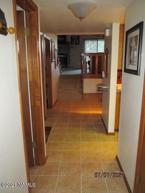 2422 N Whispering Pines Way, Flagstaff, AZ 86004 - corridor with light tile patterned floors and baseboards