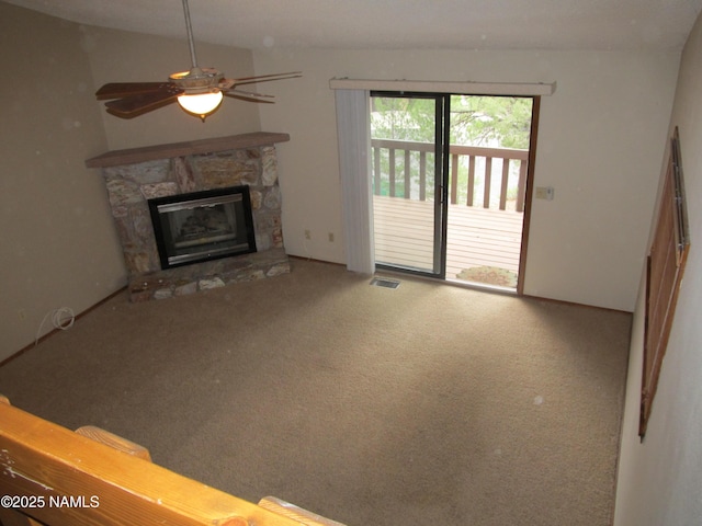 2422 N Whispering Pines Way, Flagstaff, AZ 86004 - unfurnished living room featuring a stone fireplace, carpet flooring, and ceiling fan